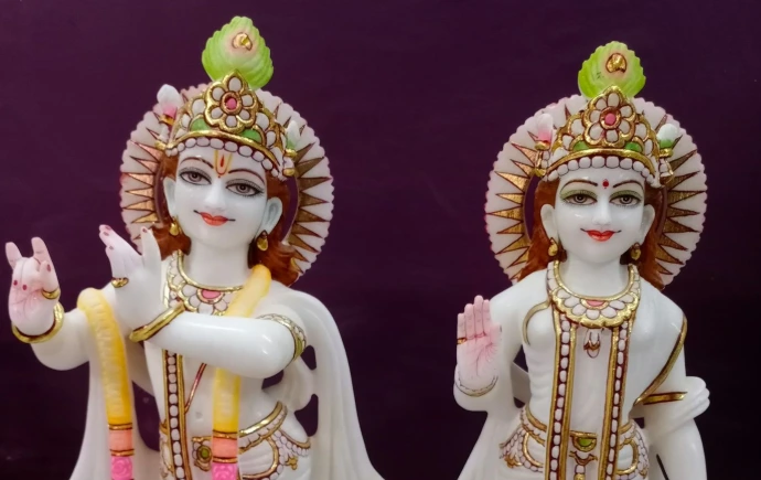 2 gold and red hindu deity figurines